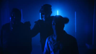 a group of people standing in a dark room