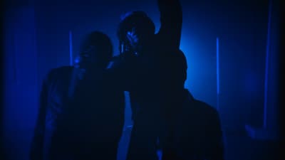 a couple of people standing in a dark room