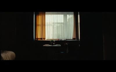 a dark room with a sink and a window