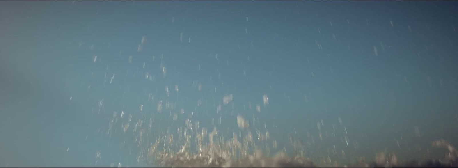 a snowboarder in the air on a clear day