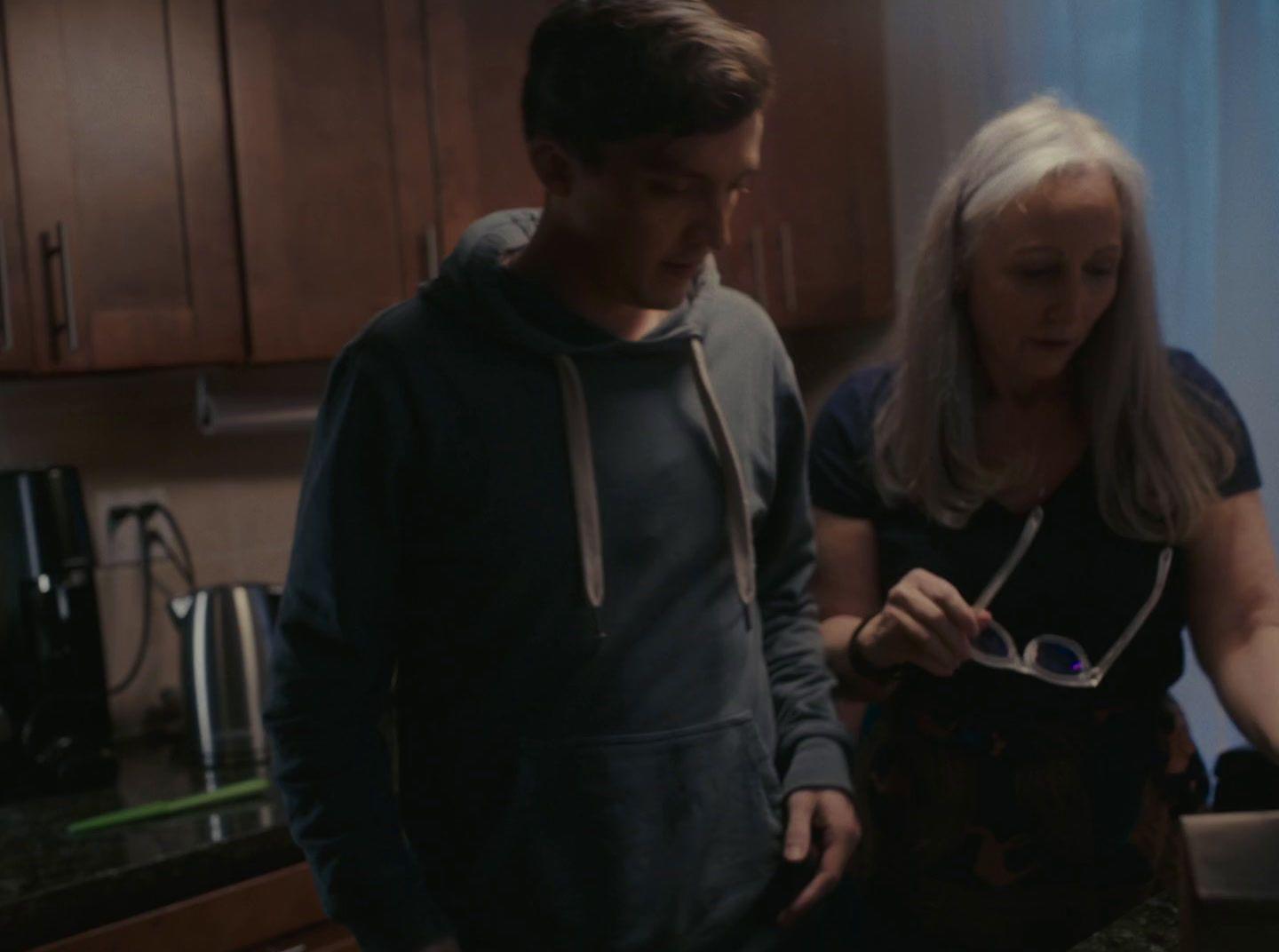 a woman standing next to a man in a kitchen