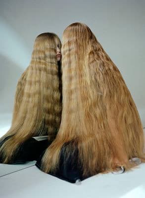 a couple of long blonde hair sitting next to each other