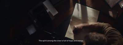 a person writing on a piece of paper