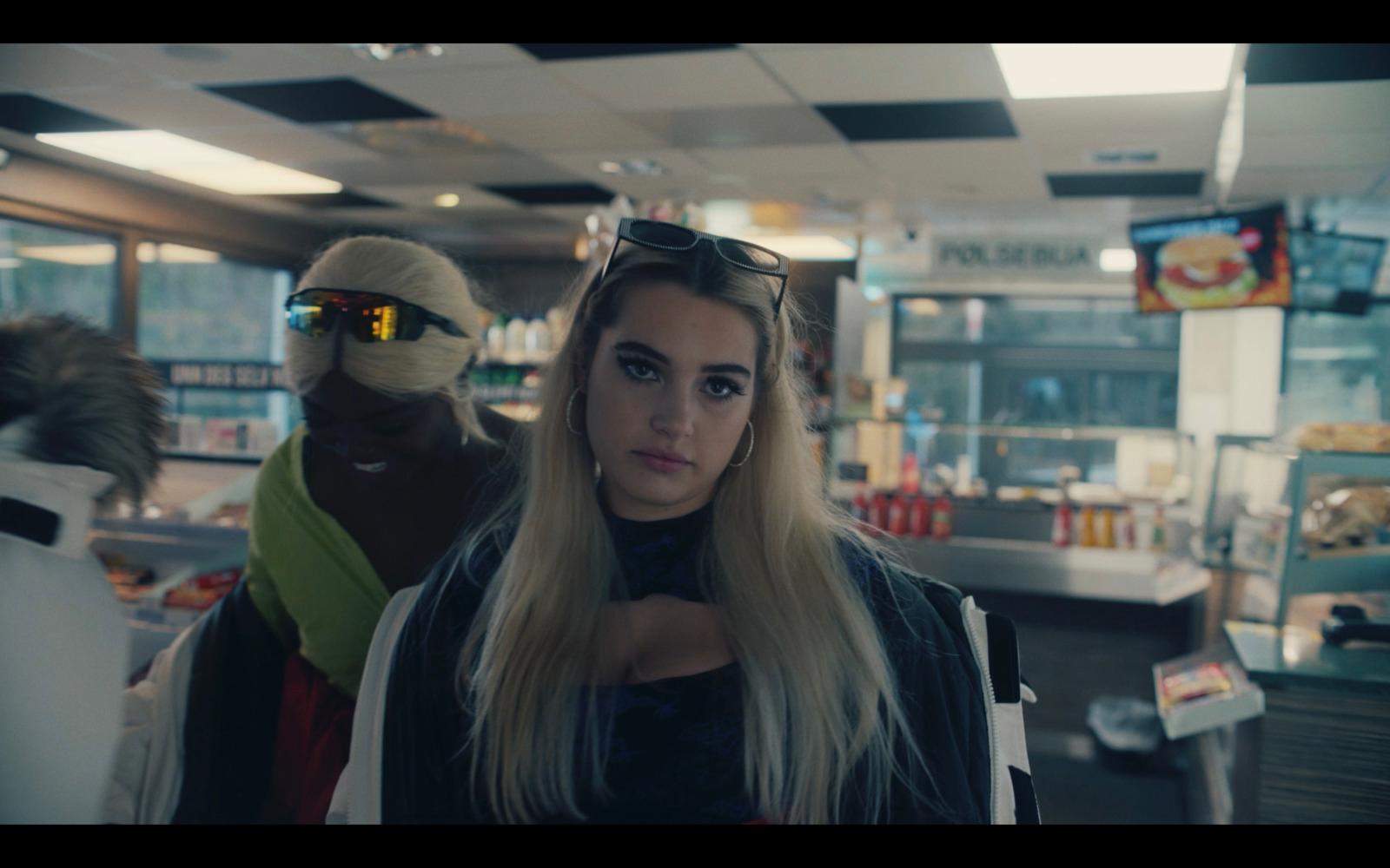 a woman with long blonde hair standing in a store