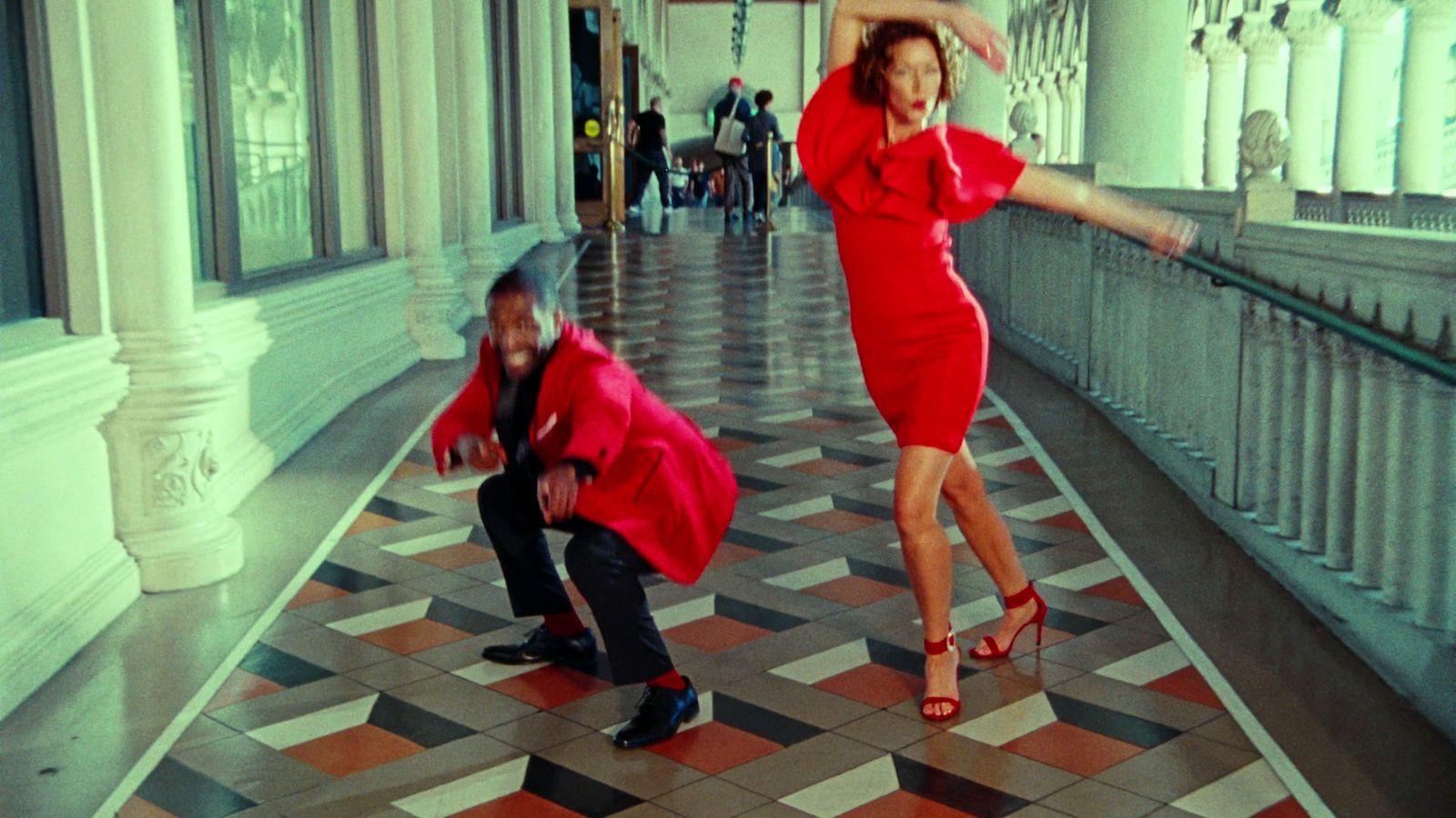 a woman in a red dress and a man in a black suit
