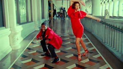 a woman in a red dress and a man in a black suit