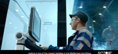 a man standing in front of a computer monitor