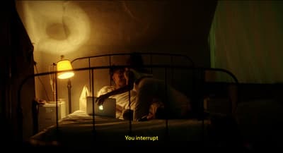 a man laying in bed using a laptop computer