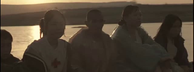 a group of people standing next to each other near a body of water