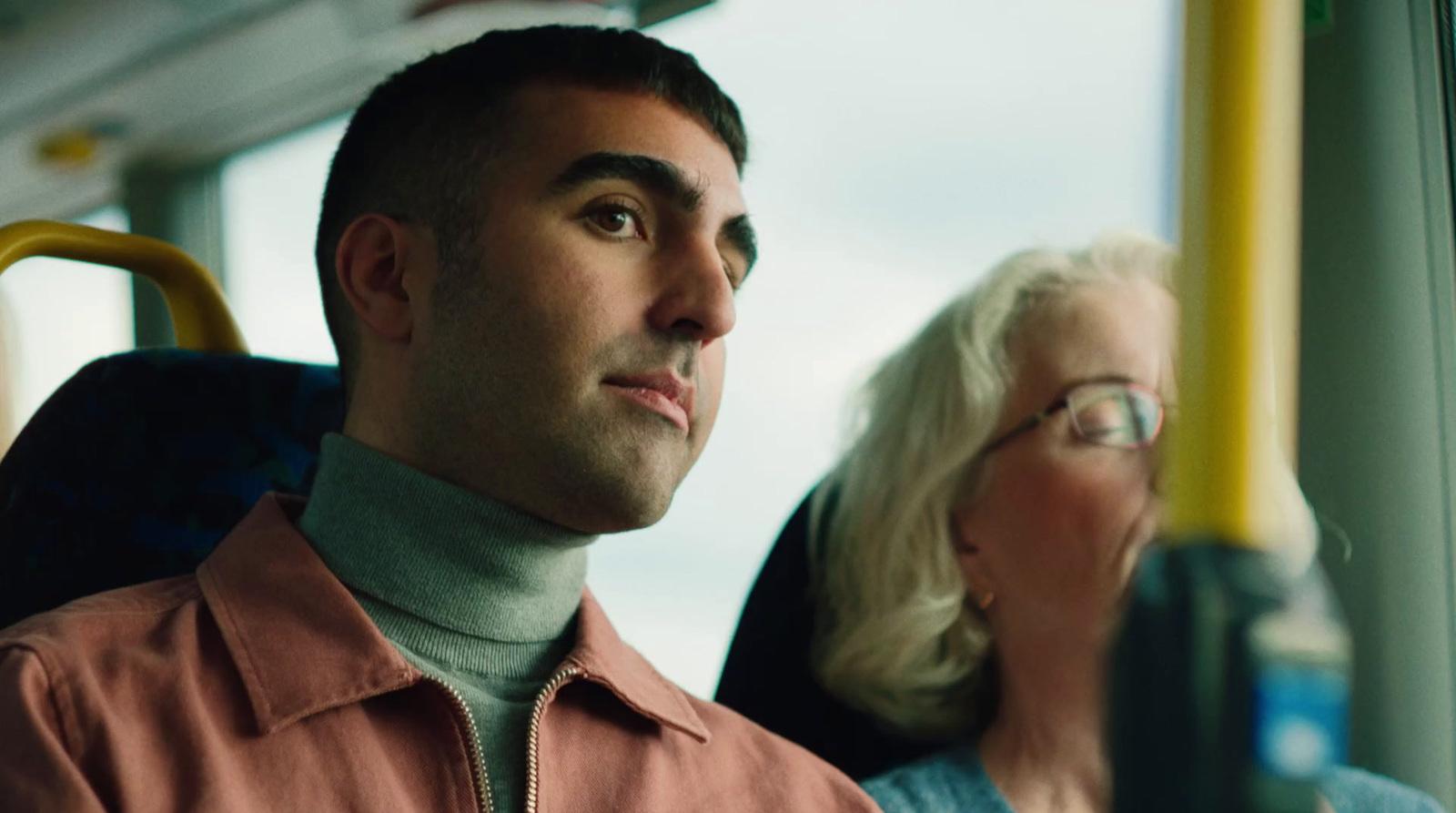 a man and a woman sitting on a bus