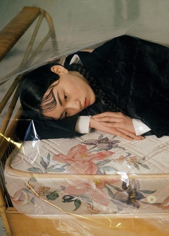a woman laying on top of a bed in a room