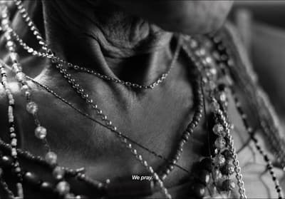 a close up of a woman wearing a necklace