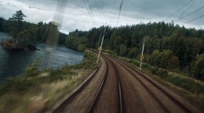 a view of a train track and a body of water