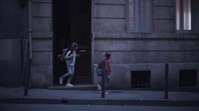 a couple of people that are standing outside of a building