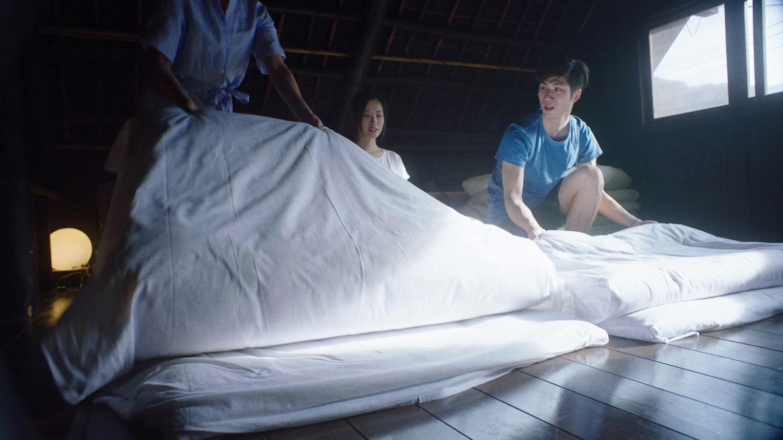 a couple of people that are sitting on a bed