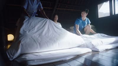 a couple of people that are sitting on a bed