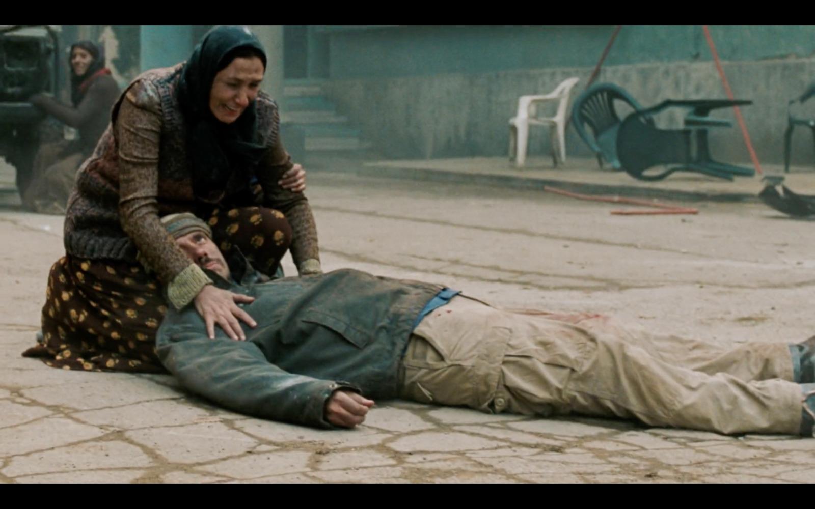 a man laying on the ground next to a woman