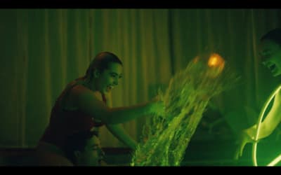a woman is pouring water onto a man's face