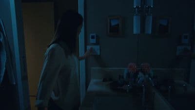 a woman standing in front of a bathroom sink