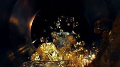 a close up of a metal object with water on it