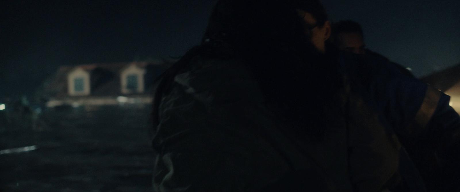 a man and a woman standing in the dark