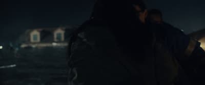 a man and a woman standing in the dark