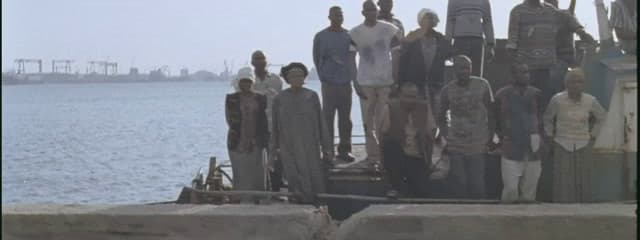 a group of people standing on top of a boat