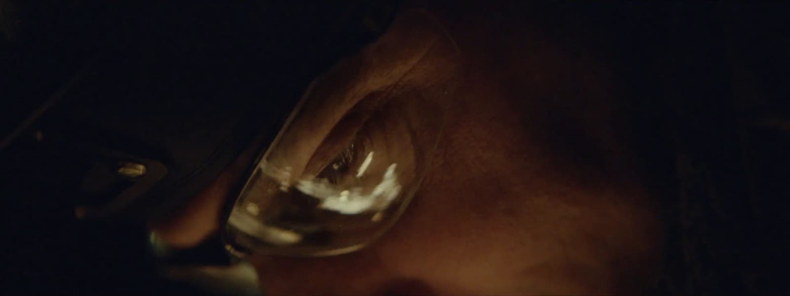 a close up of a person holding a wine glass