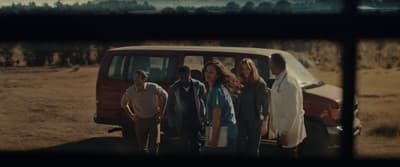 a group of people standing in front of a van