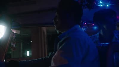 a man standing next to a woman in a dark room