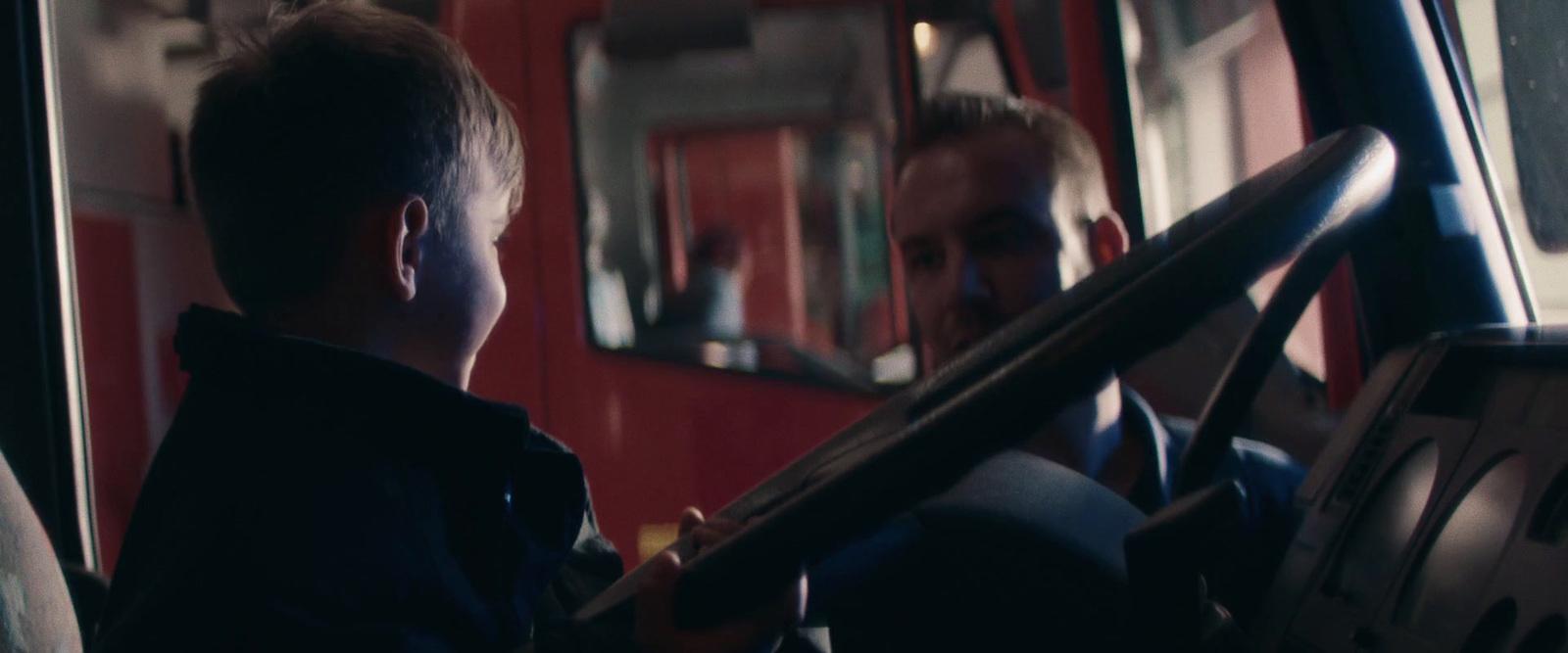 a man and a young boy sitting on a bus