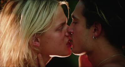 a man and a woman kissing each other