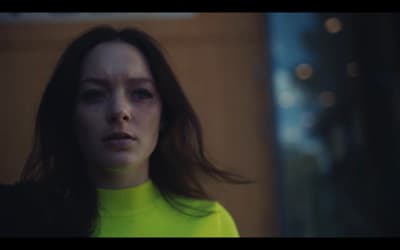 a woman in a green turtle neck sweater