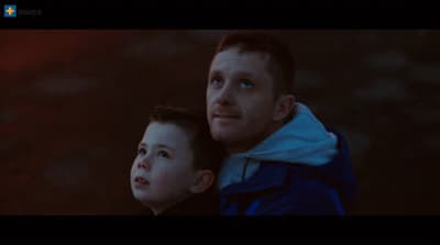 a man and a boy are looking at something