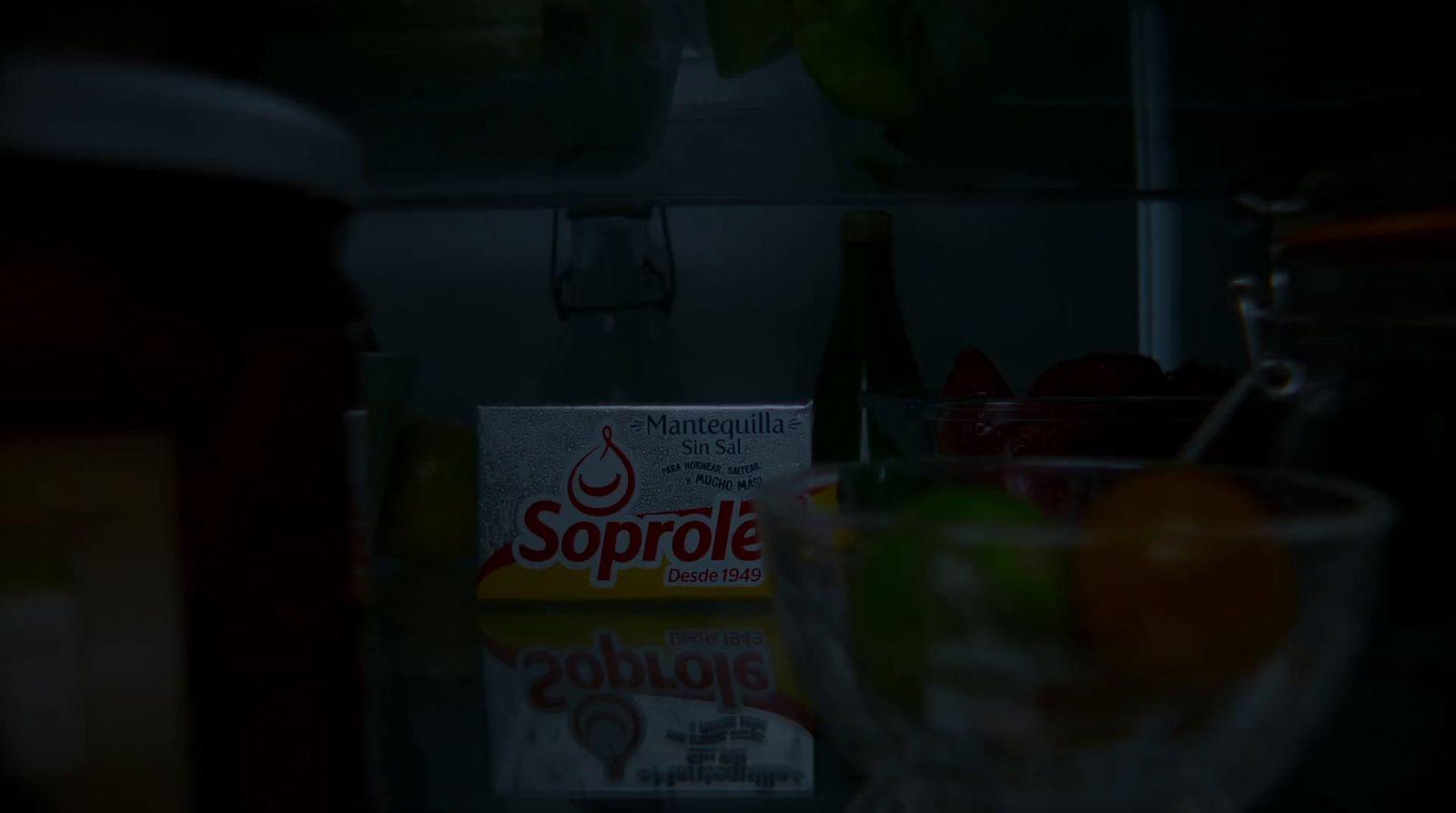 a box of soup sits on a counter next to a bowl of fruit