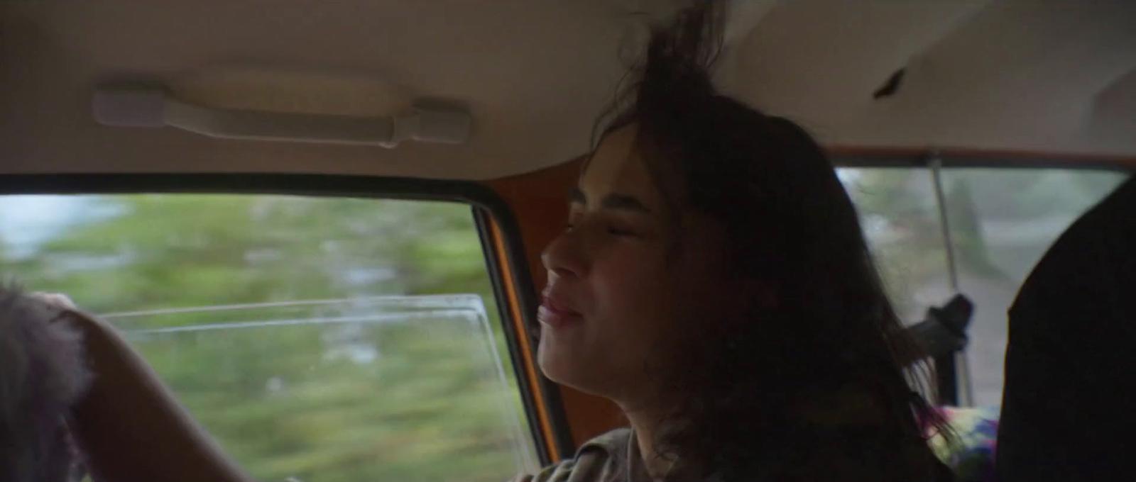 a woman sitting in the passenger seat of a car