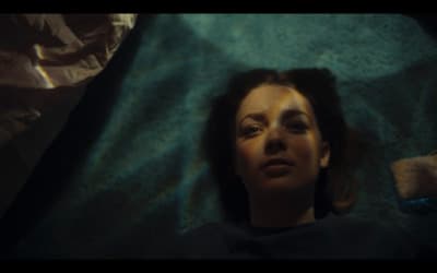 a woman laying on a bed with her eyes closed