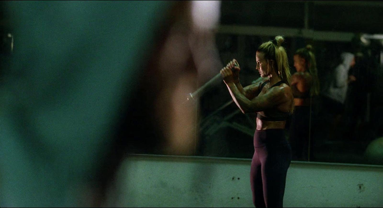 a woman holding a stick in front of a mirror