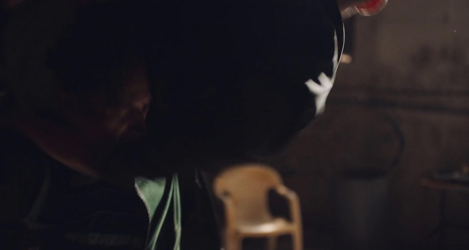 a man sitting in a chair in a dark room