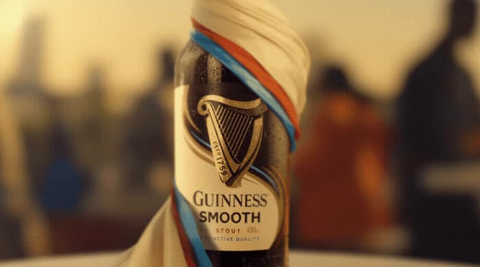 a bottle of guinness smoothie sitting on top of a table