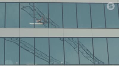 an airplane is flying in the sky through the windows of a building