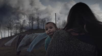a woman holding a baby in her arms