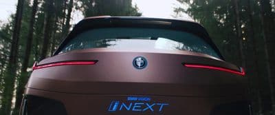 the rear end of a brown sports car