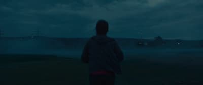 a person standing in a field at night