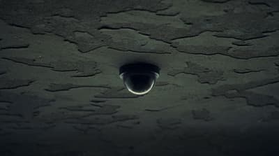 a black and white photo of a light in the dark