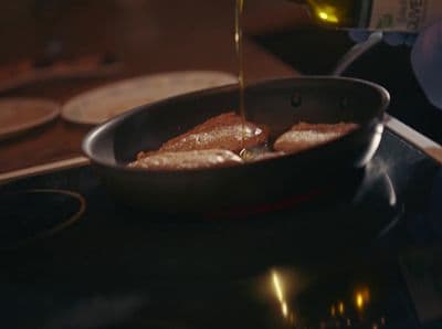 a pan filled with food sitting on top of a stove
