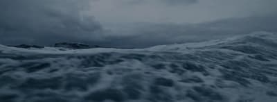 a large body of water under a cloudy sky