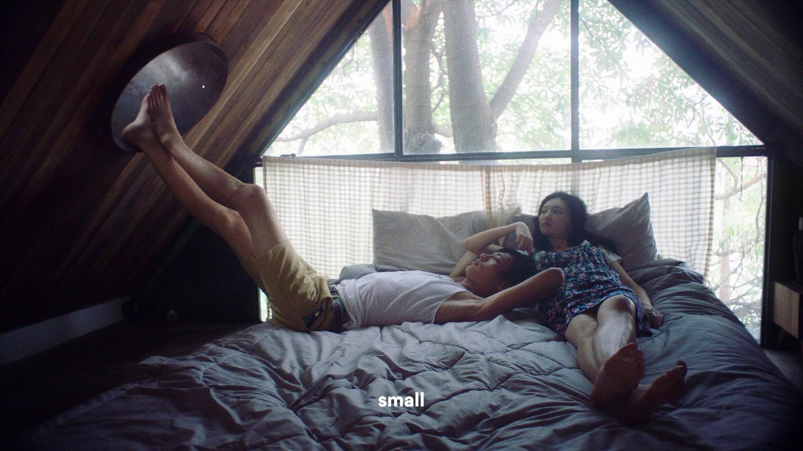 a man and a woman laying on a bed