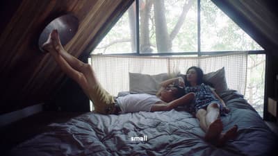 a man and a woman laying on a bed