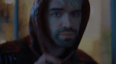 a man in a hoodie looking at the camera